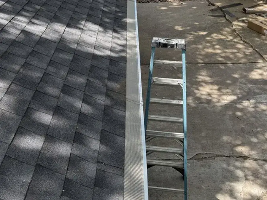 Clean gutter with new gutter guard installed along a DFW roofline