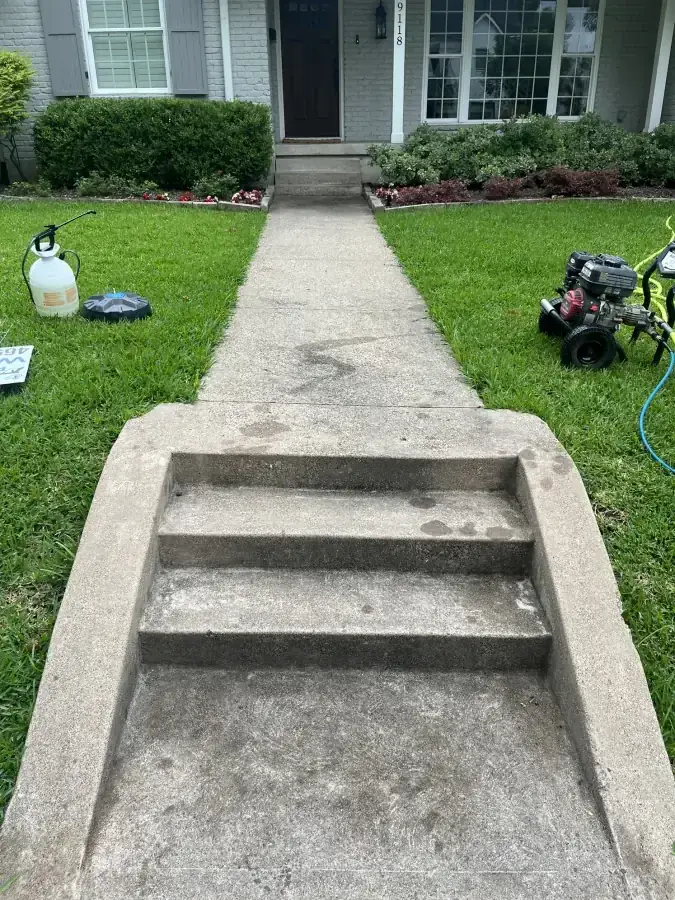Front steps and walkway darkened by grime before power washing in McKinney